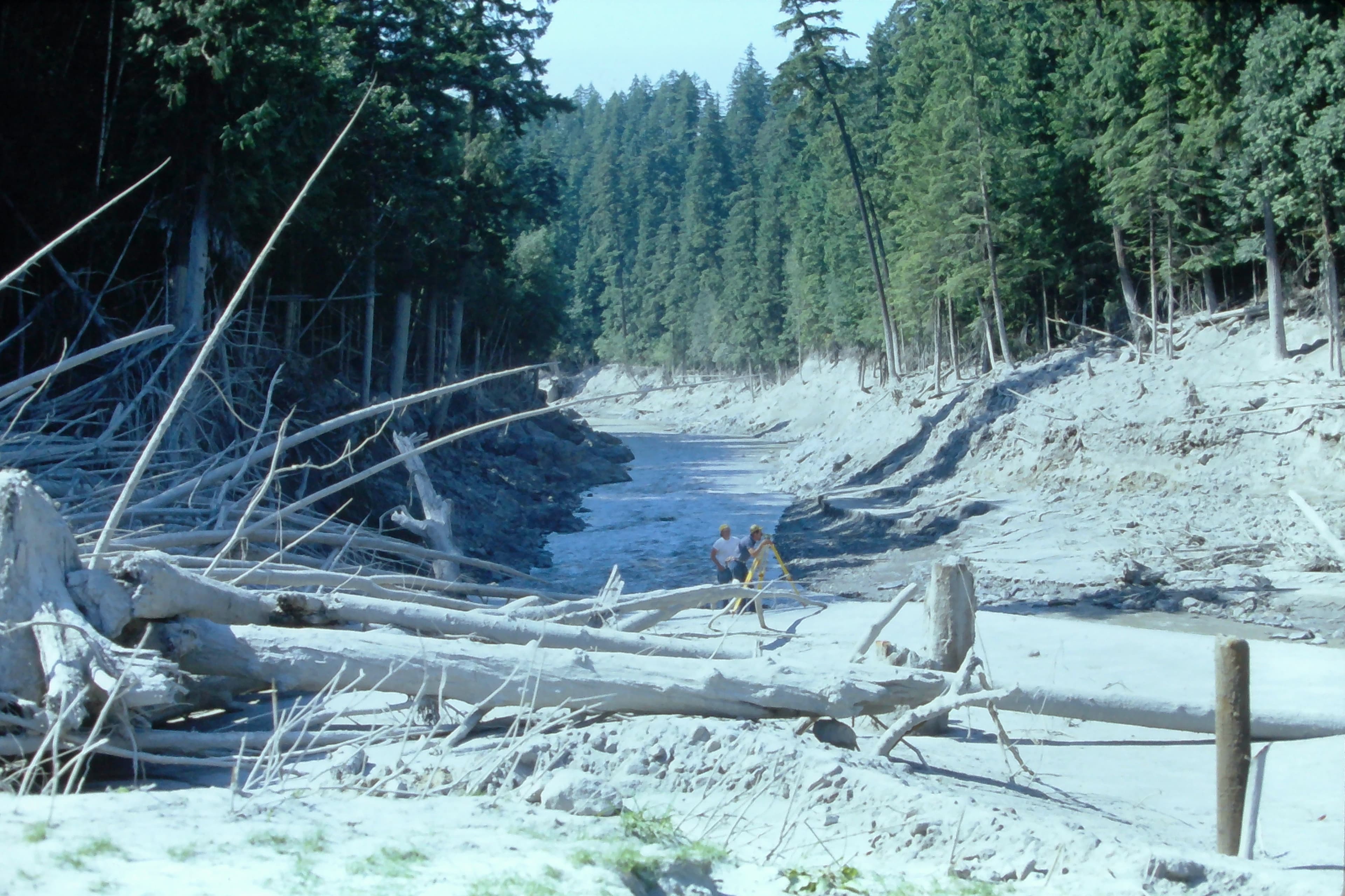 July 1980 Ron Lombard and Mory Miles surveying a cross section on the South Fork Toutle River near Four Corners. USGS K. Tanner